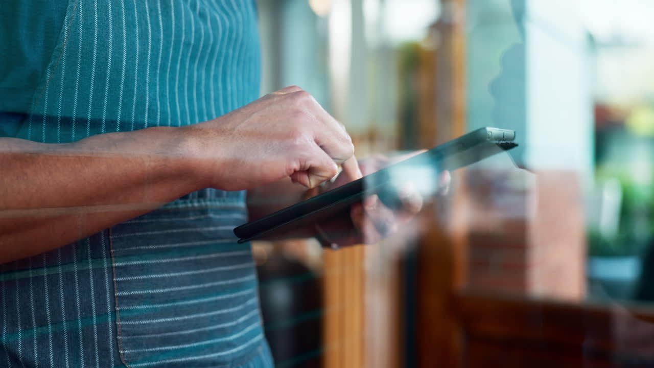 Hands, tablet and a waiter in a cafe for an online