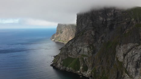 cinematic drone shot of the isolated mountain cliffs at kvalvika beach in the lofoten islands norway, aerial shot