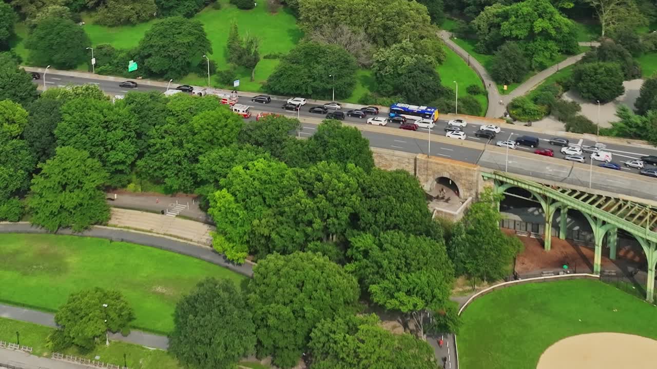 Drone view of greenery and traffic near waterfront in New York City