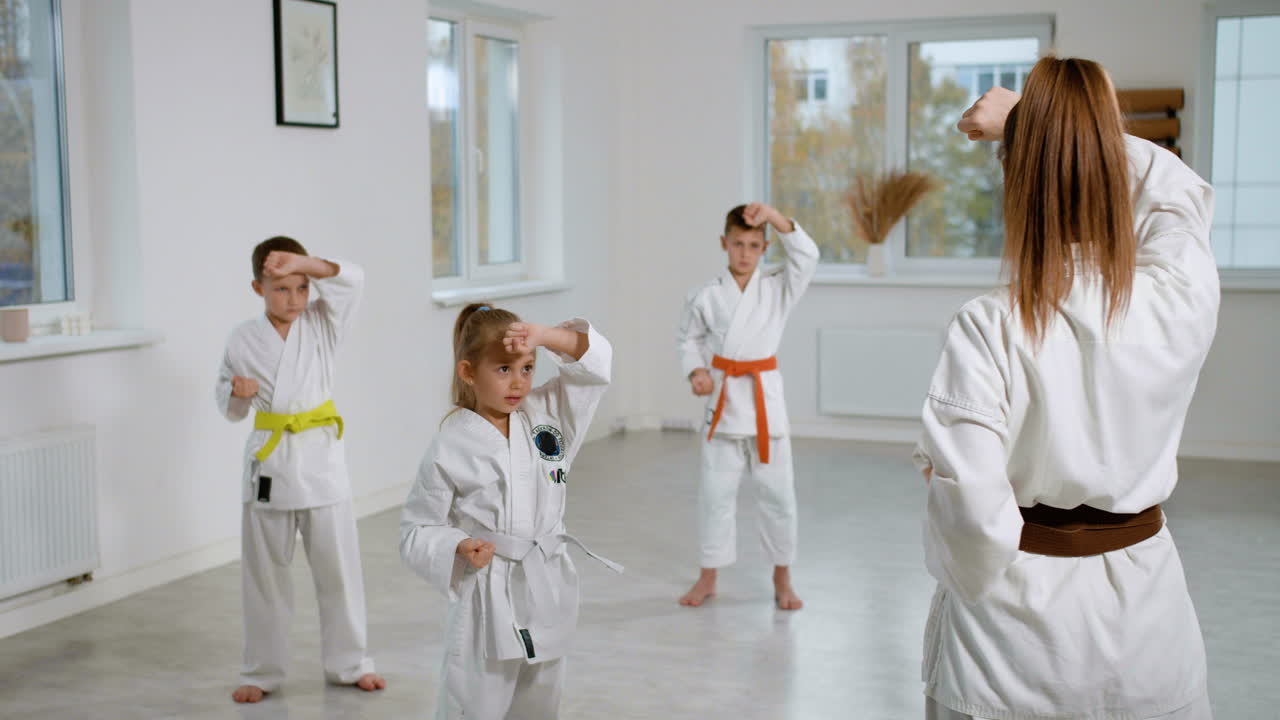 Kids in white kimono in martial arts class