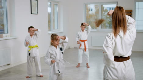 kids in white kimono in martial arts class