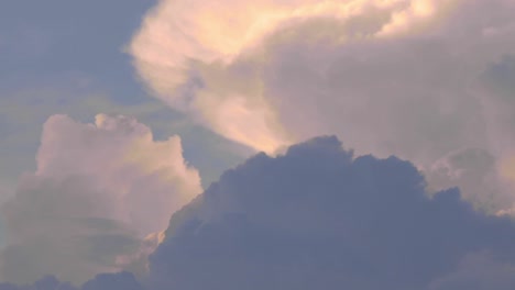 Billowing-clouds,-cumulonembus-growing-a-storm-at-the-sunset