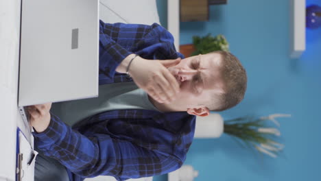 Vertical-video-of-Home-office-worker-man-is-sick-and-coughing.