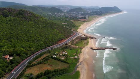 aerial drone shot of vizag city in the early morning light, with the city slowly coming to life as the sun rises over the ocean.
