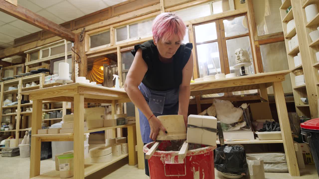 Woman making pottery in a workshop