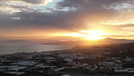 Beautiful-sunset-shot-from-dropping-down-over-Spanish-countryside-with-clouds-over-sea