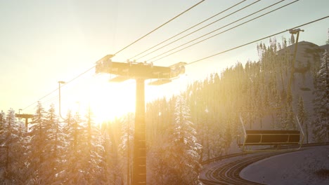 empty ski lift. chairlift silhouette on high mountain over the forest at sunset