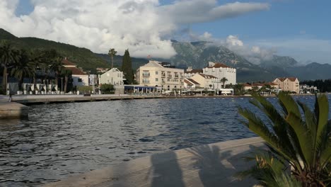 Seaside-town-boulevard,-palm-tree-and-mountains,-Mediterranean