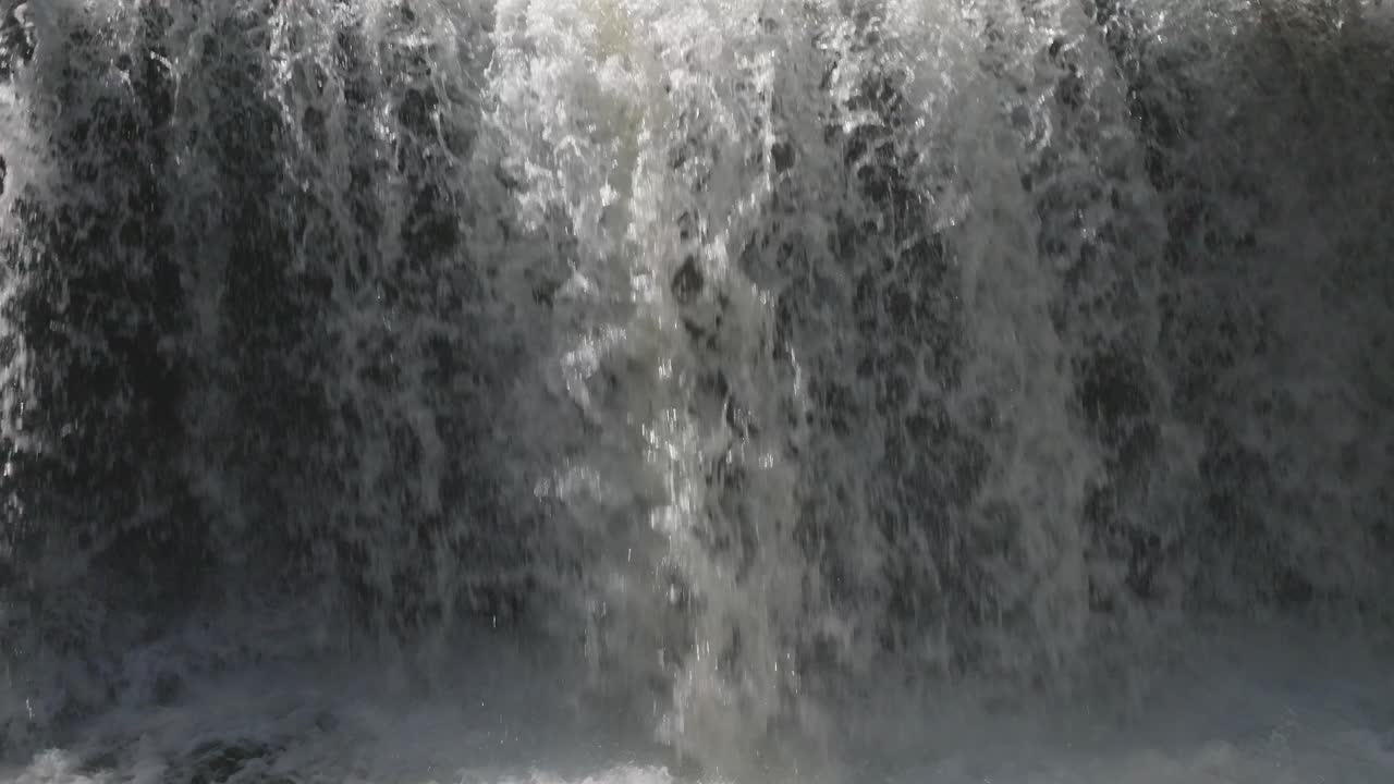 Cascading waterfall in Owen Sound, Canada, during daytime, creating a powerful and serene scene