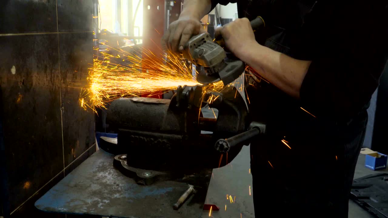 작업장 에서 금속 을 자르는 가공기 를 사용 하는 노동자 의 근접 사진
