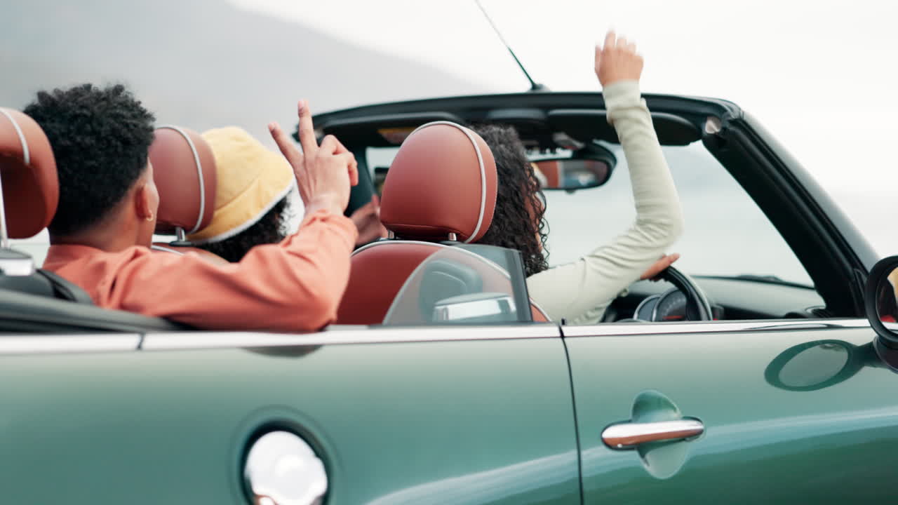Friends enjoying a road trip in a convertible
