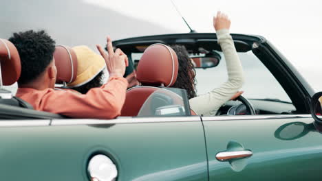 friends enjoying a road trip in a convertible