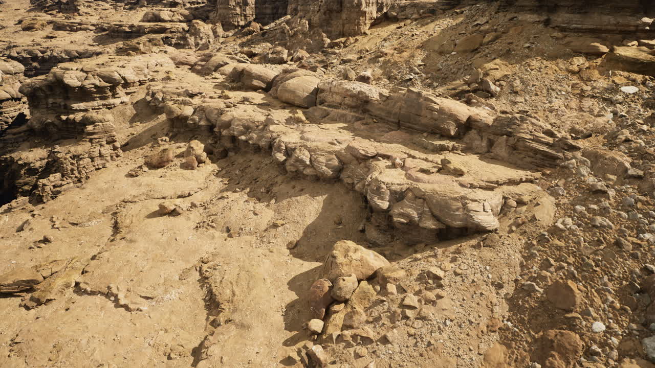 Rocky geological formation in a dry desert landscape during daylight