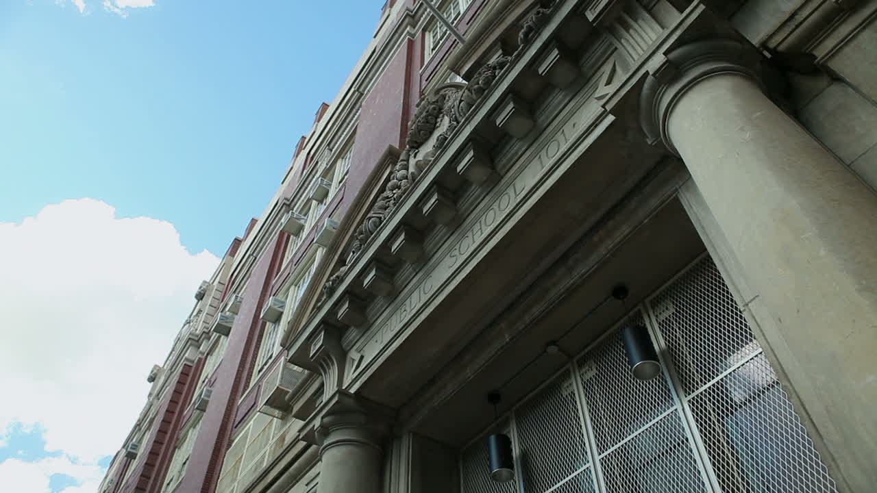Dolly shot of the front of a public school building