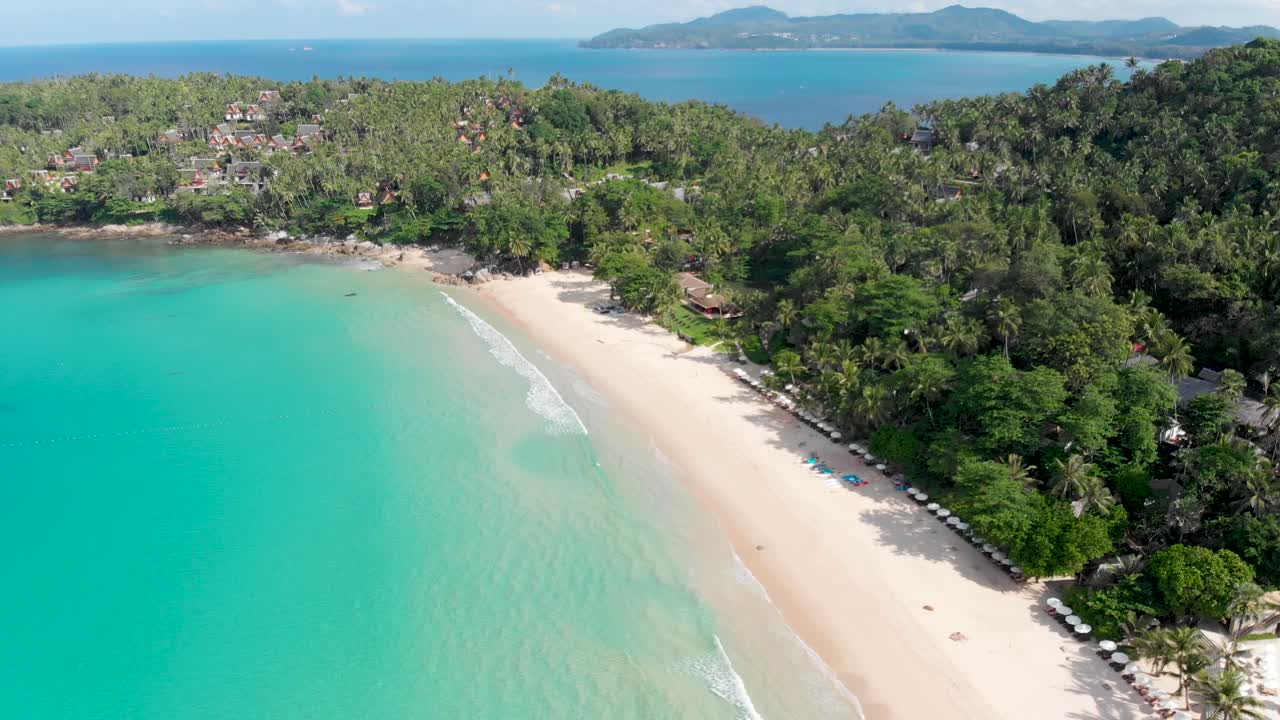 An overhead aerial drone shot panning from right to left of Pansea, a secluded beach in the west coast of Phuket, Thailand