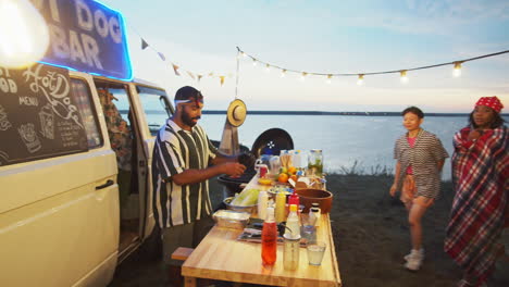 man turning on lights and start selling street food at truck