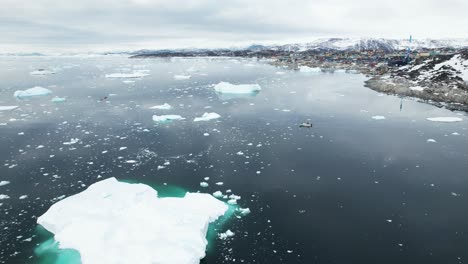 Town-of-Ilulissat-and-majestic-icefjord-in-Greenland,-aerial-view