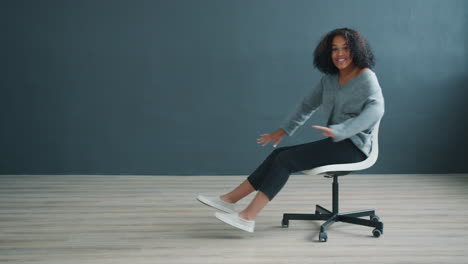 happy woman posing on an office chair