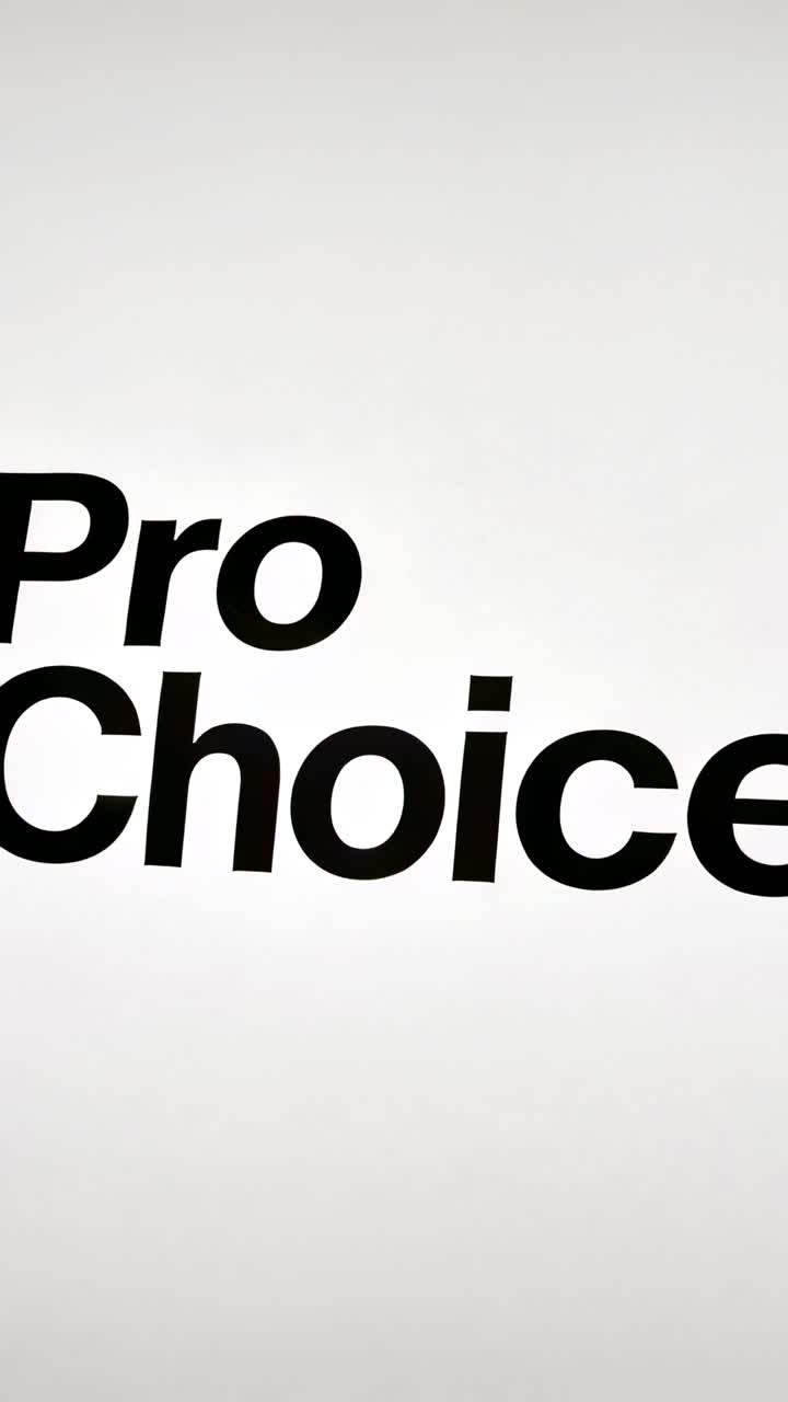 Vertical video: Sliding black Pro Choice type moving from crop into center revealing on gradient