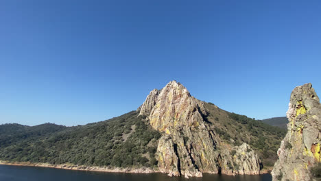 eautiful shot of a mountain on the shores of a lake in ribera del duero in spain during daylight