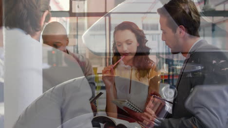 Animation-of-wheel-over-diverse-colleagues-discussing-work-in-office