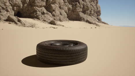 a lone tire lies in the desert sand