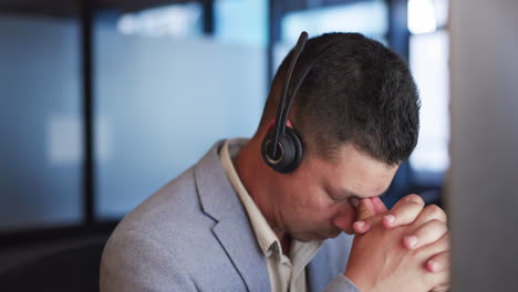 Call-center,-stress-and-man-with-burnout-in-office