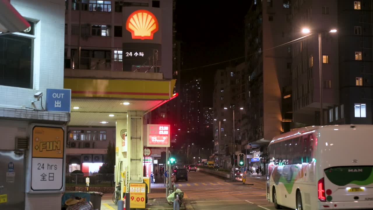 Night view of a Shell gas station and a busy city street