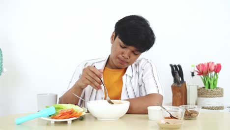 a person eating noodles and salad at a table