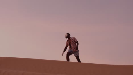 african american man dancing uganda style in desert