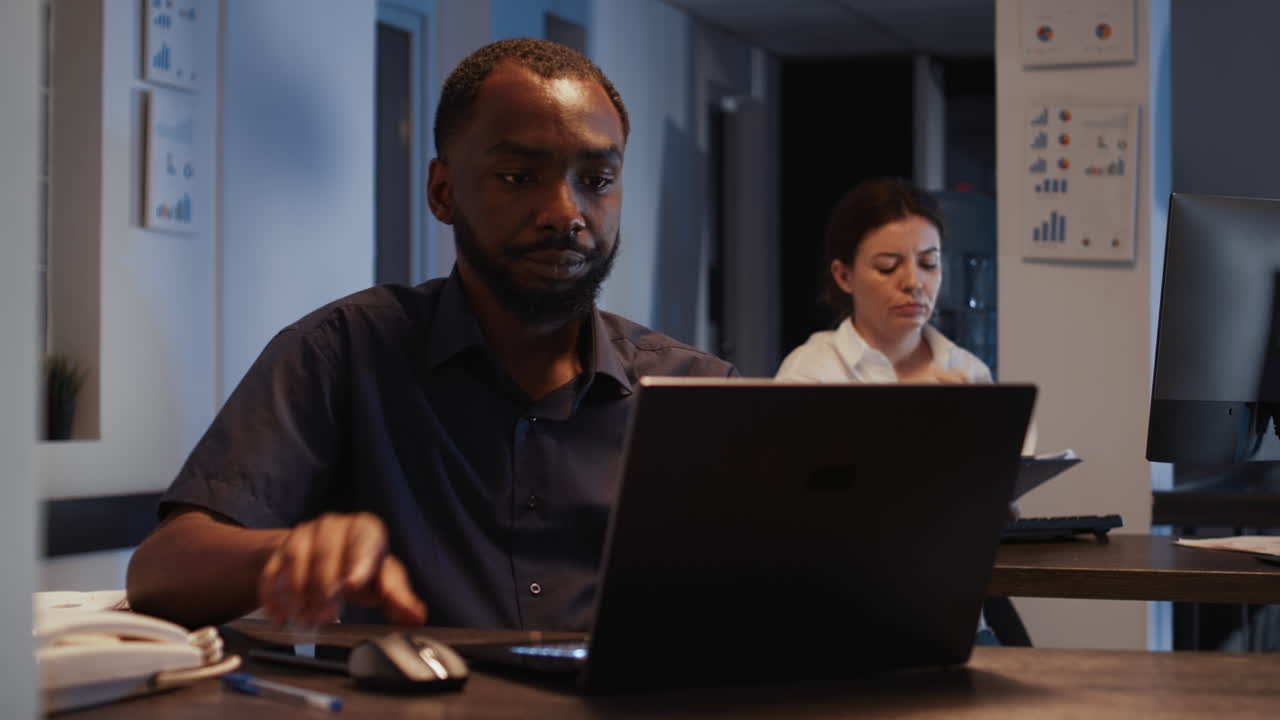 African american man working on laptop in startup office