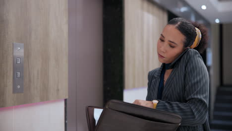 businesswoman on a phone call in an elevator
