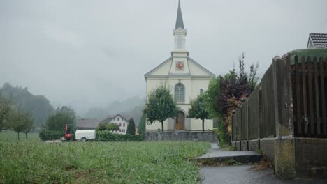 church slow zoom trees rain path fog cloudy