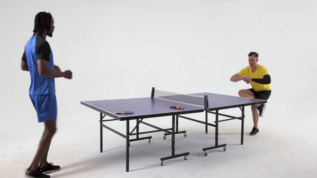 Multiracial male table tennis players warming up before game of table tennis on white background