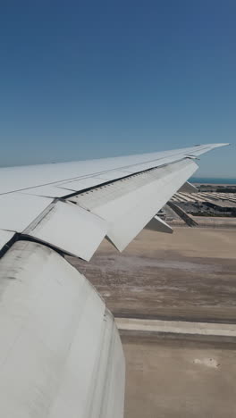 view from a plane window of the sky with the wing shot in vertical