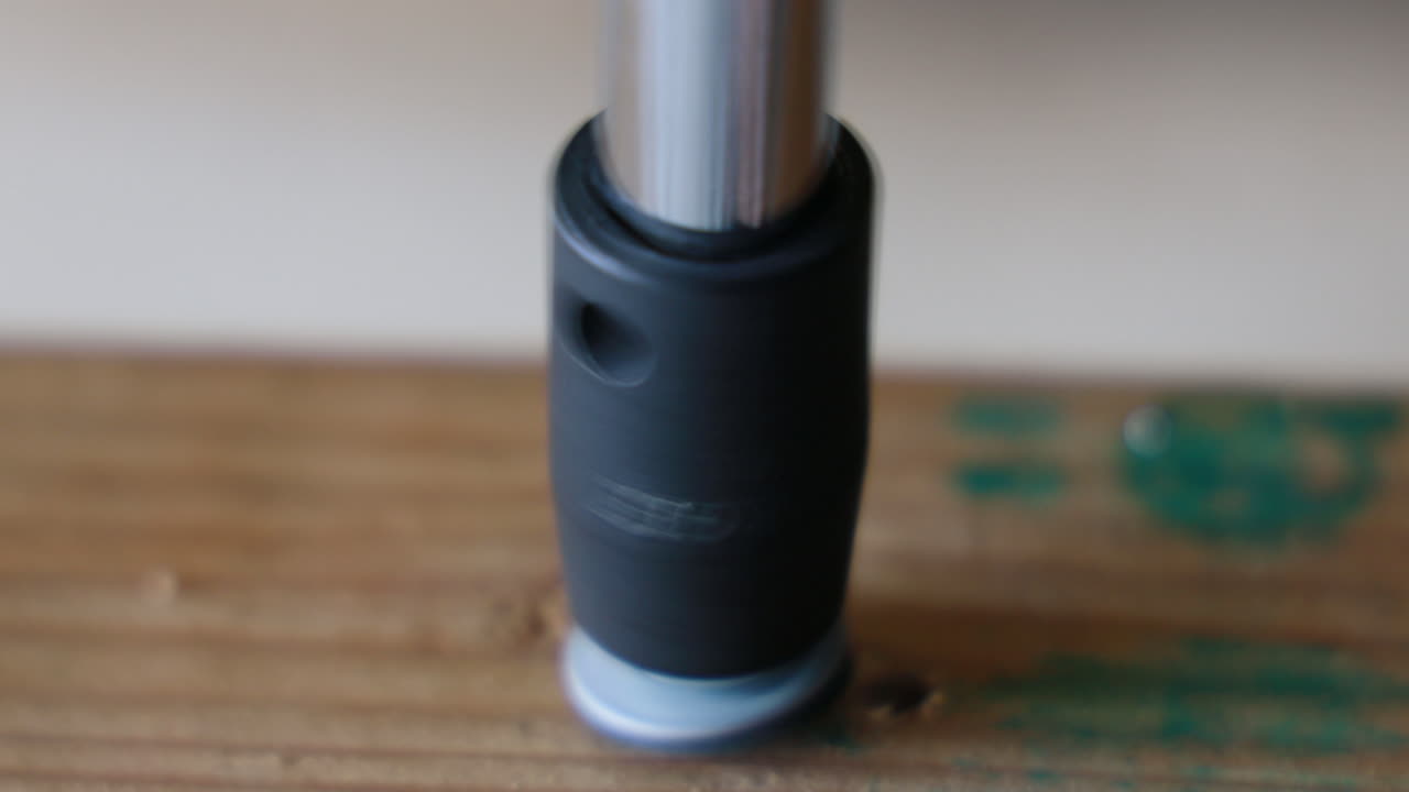 Using a ratchet and socket to thread a bolt into a piece of wood