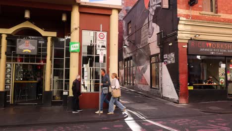 people walking past a chinatown building