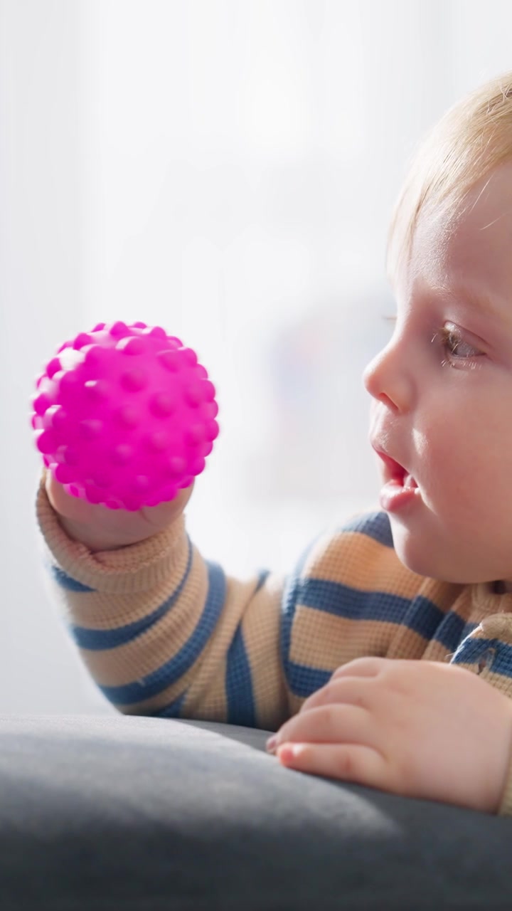 Cute Baby Boy Playing with a Pink Spiky Sensory Ball