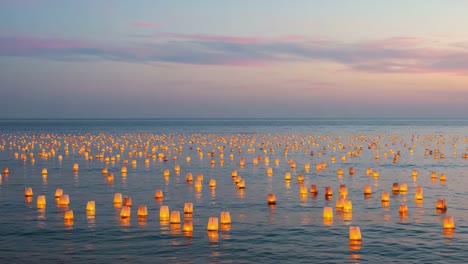 a serene evening as water lanterns illuminate the calm surface, creating a magical atmosphere under the twilight sky with reflections of light