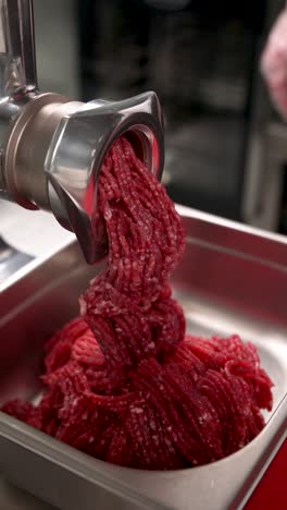 mincing meat with a meat grinder