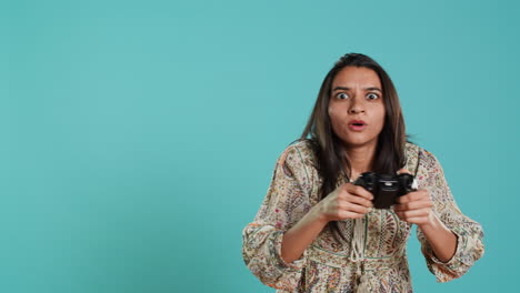 Joyful-woman-showing-thumbs-up-sign-gesturing-while-holding-controller