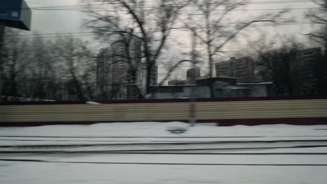 passing by winter city view from moving train