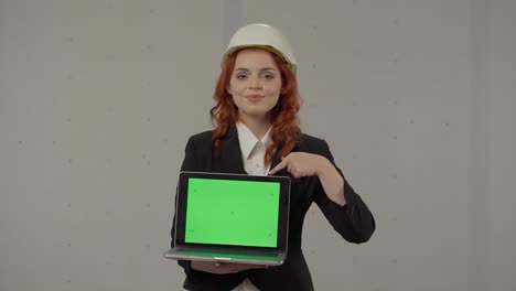 woman engineer presenting green screen laptop