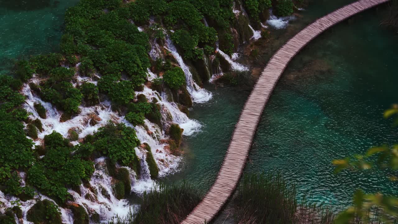 Waterfalls flowing gently at wooden path. Plitvice Lakes, Croatia. Blue pool, turquoise water