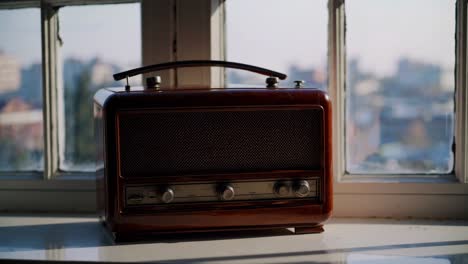 vintage radio on window sill with city view