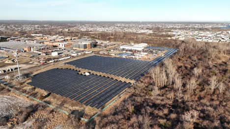 An-aerial-view-of-many-large-solar-panels-on-a-beautiful-day-with-blue-skies