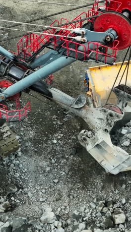 giant excavator digging rocks at a mining site