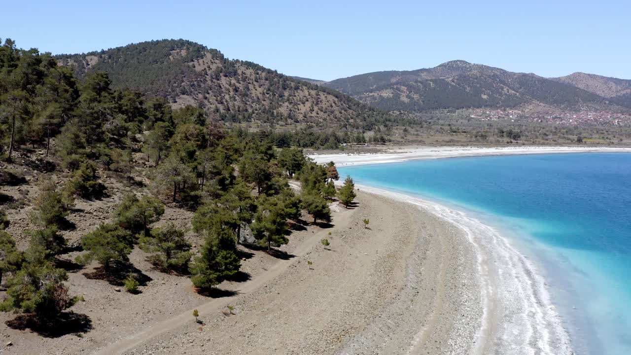 Drone flight to Turkish hills over turquoise Lake Salda white shoreline