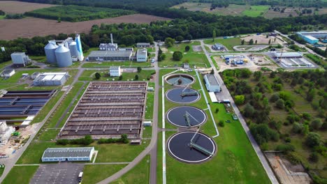 modern sewage treatment plant facility showing sedimentation tanks, aeration tanks, and clarifiers, domestic wastewater treatment municipal installation for reuse. best aerial view panorama drone