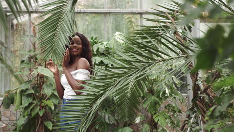 woman posing in a greenhouse